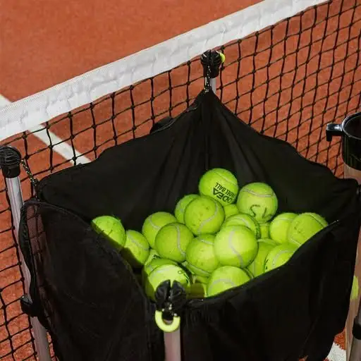A basket of padel balls at the net